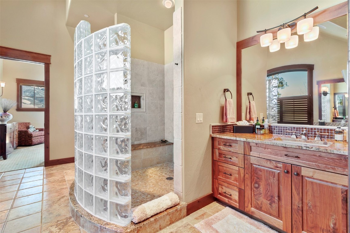 1680 Golden Eagle Road Silverthorne, CO 80498 - Photo 16 of 40 a bathroom with a double vanity sink and a mirror