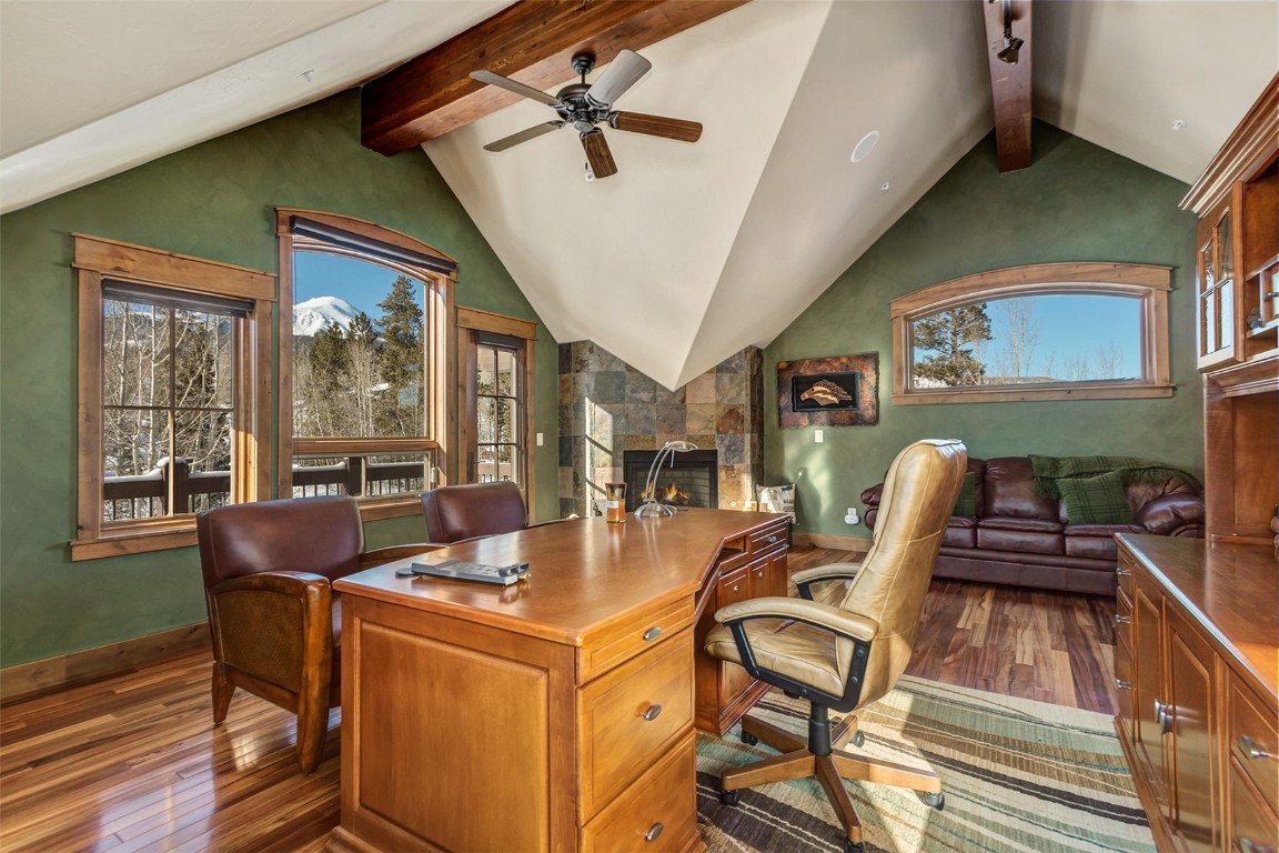 1680 Golden Eagle Road Silverthorne, CO 80498 - Photo 17 of 40 a dining room with furniture a floor to ceiling window and wooden floor