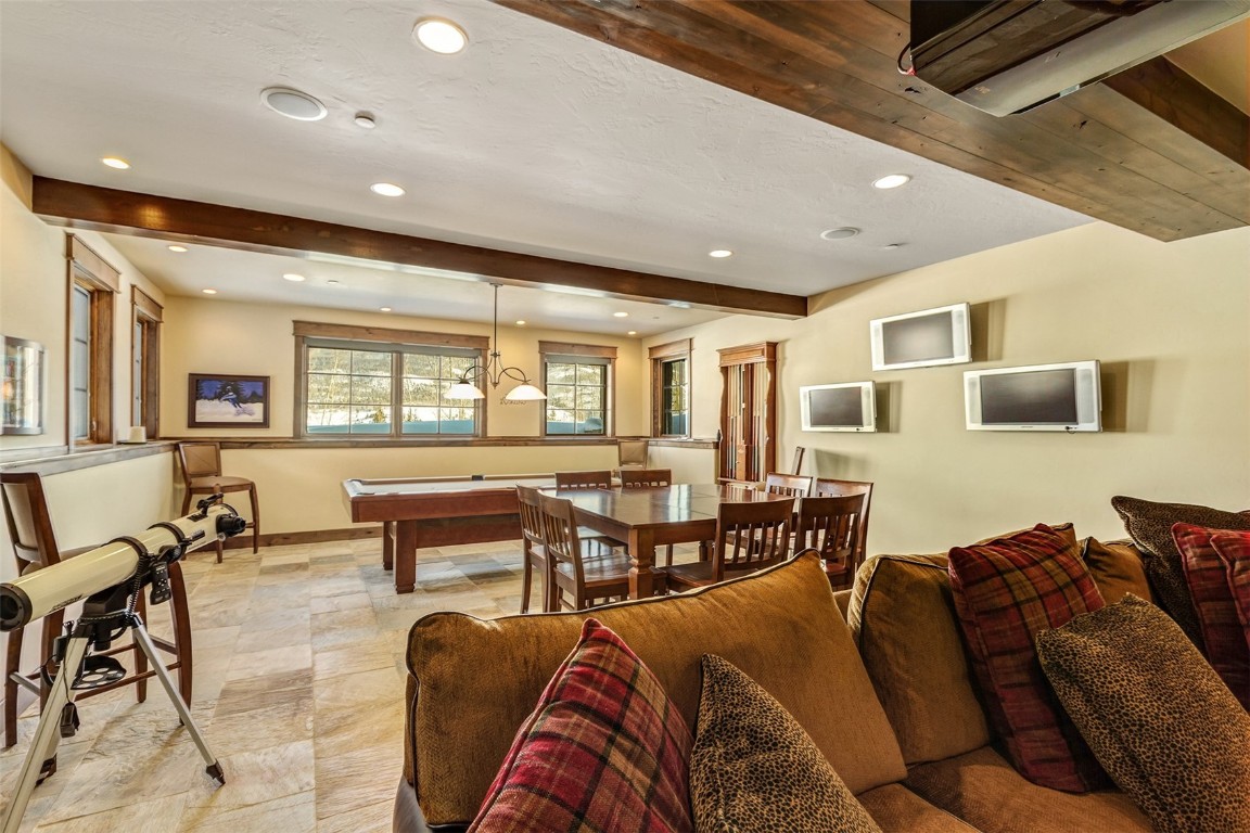 1680 Golden Eagle Road Silverthorne, CO 80498 - Photo 21 of 40 a living room with furniture kitchen view and a wooden floor