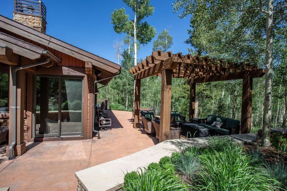 1680 Golden Eagle Road Silverthorne, CO 80498 - Photo 26 of 40 a view of a patio with table and chairs potted plants with large tree