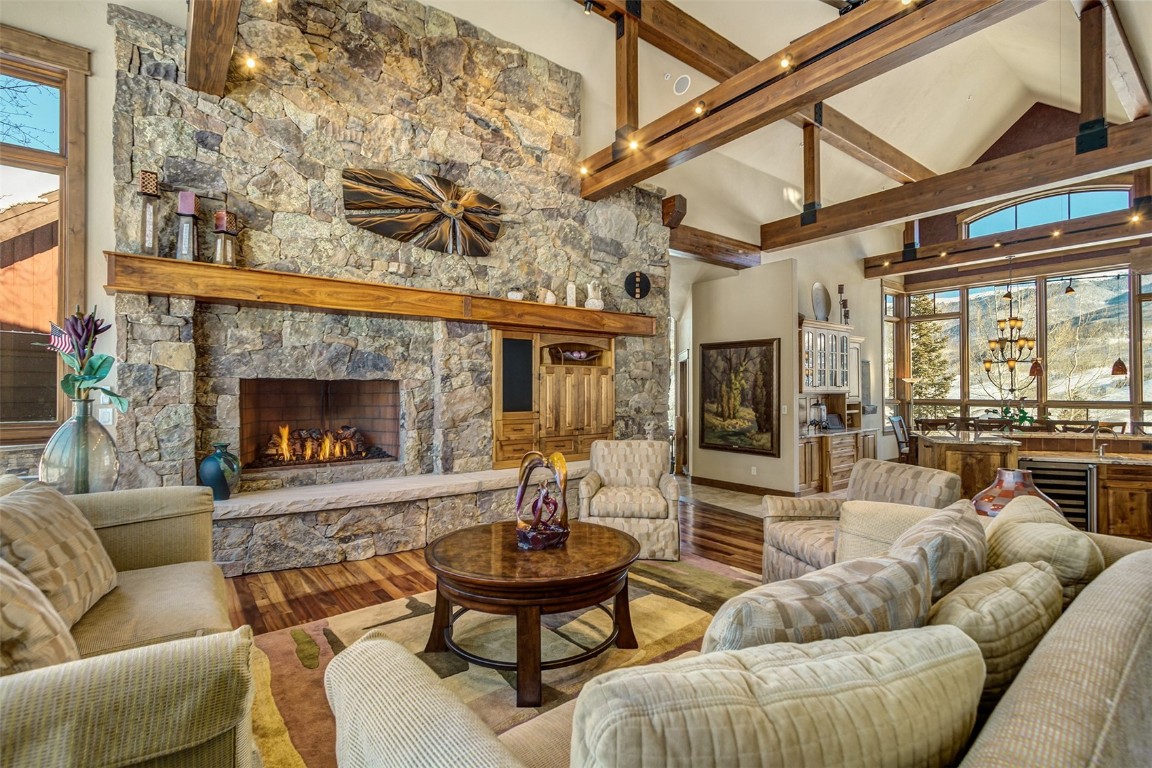 1680 Golden Eagle Road Silverthorne, CO 80498 - Photo 6 of 40 a living room with furniture a fireplace and a flat screen tv