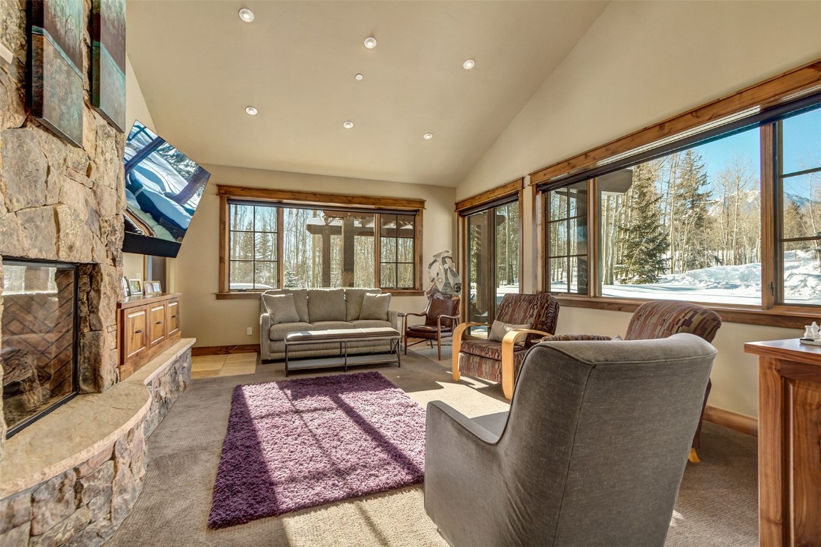 1680 Golden Eagle Road Silverthorne, CO 80498 - Photo 9 of 40 a living room with furniture and a fireplace