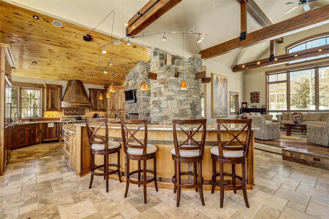 1680 Golden Eagle Road Silverthorne, CO 80498 - Photo 10 of 40 a dining hall with stainless steel appliances kitchen island granite countertop a table chairs and view living room