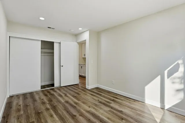 a kitchen with a stove and white cabinets