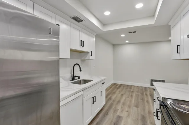 a kitchen with stainless steel appliances granite countertop a sink stove and refrigerator