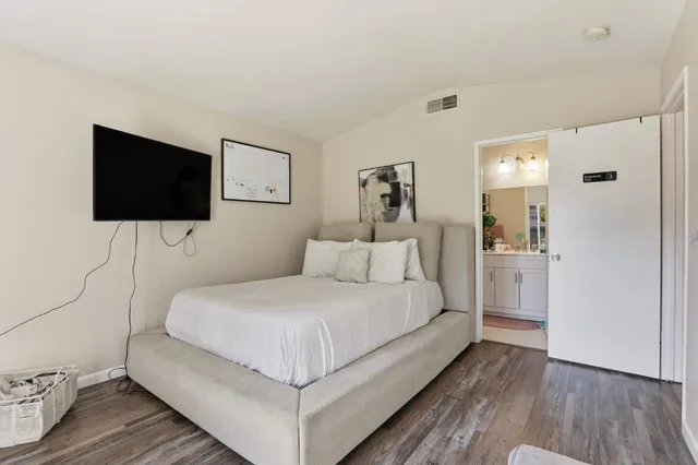 a bedroom with a bed and wooden floor