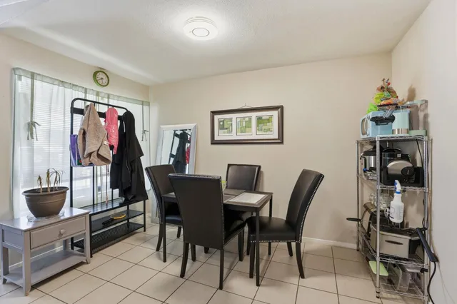 a living room with furniture a flat screen tv and a potted plant