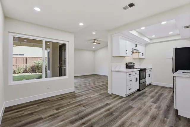 a view of kitchen with wooden floor and electronic appliances