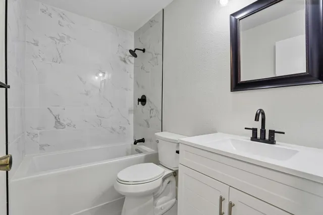 a bedroom with a large bed and a potted plant