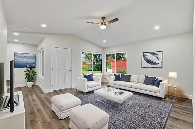 a living room with furniture and a large window