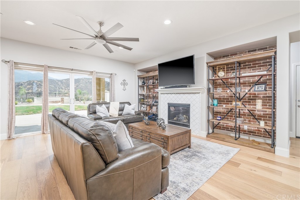 17841 Grapevine Lane San Bernardino, CA 92407 - Photo 12 of 53 a living room with furniture a flat screen tv and a fireplace