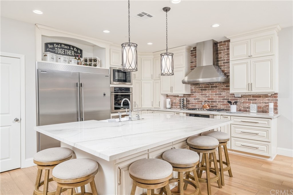 17841 Grapevine Lane San Bernardino, CA 92407 - Photo 14 of 53 a kitchen with stainless steel appliances kitchen island a table and chairs