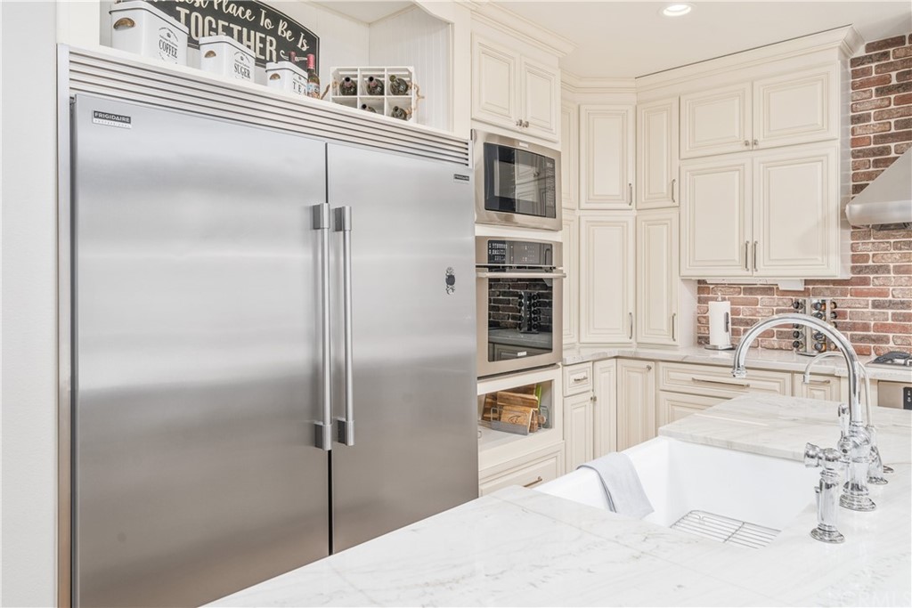 17841 Grapevine Lane San Bernardino, CA 92407 - Photo 15 of 53 a kitchen with a refrigerator sink and cabinets
