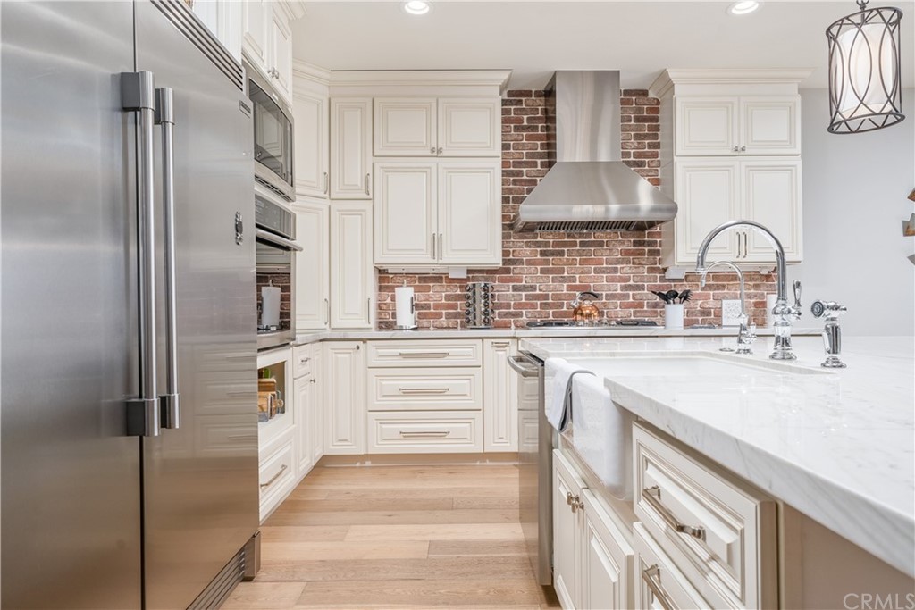 17841 Grapevine Lane San Bernardino, CA 92407 - Photo 16 of 53 a kitchen with white cabinets and refrigerator