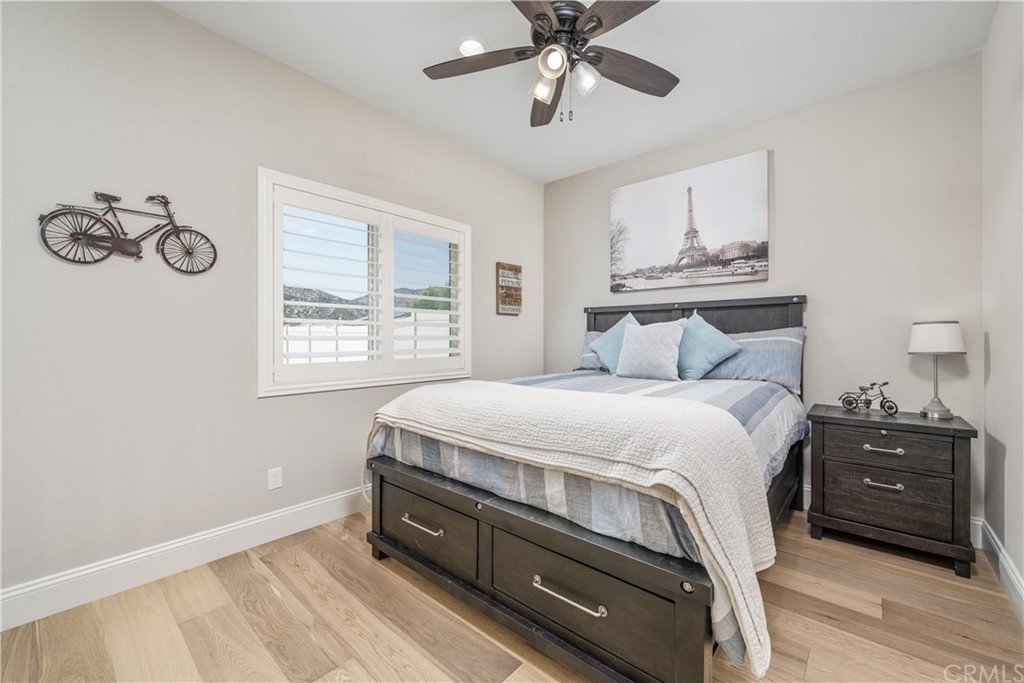 17841 Grapevine Lane San Bernardino, CA 92407 - Photo 20 of 53 a bedroom with a bed and a chandelier