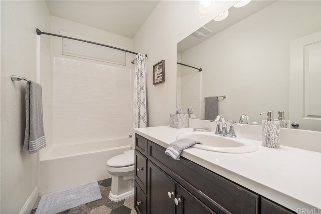 17841 Grapevine Lane San Bernardino, CA 92407 - Photo 21 of 53 a bathroom with a sink a toilet and shower