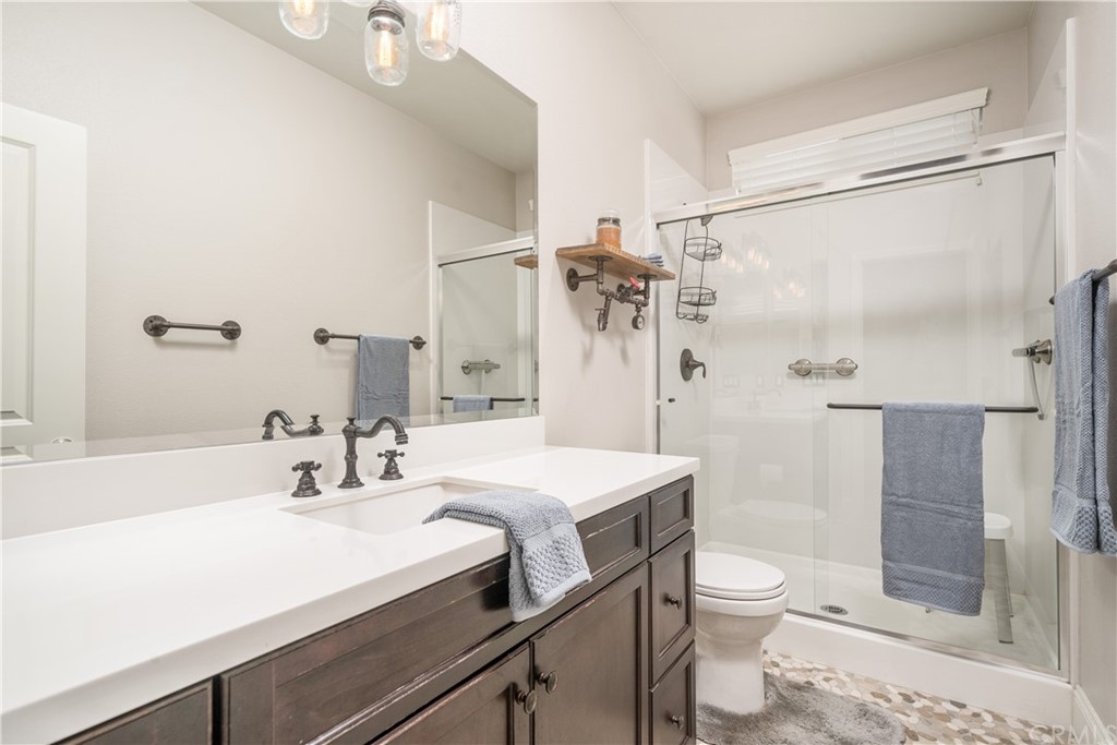 17841 Grapevine Lane San Bernardino, CA 92407 - Photo 25 of 53 a bathroom with a sink a toilet and shower