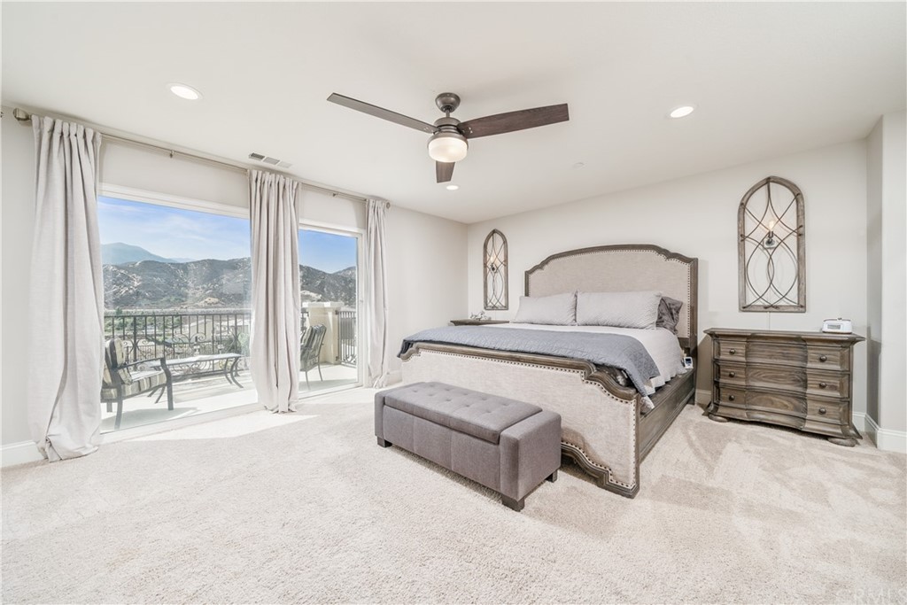 17841 Grapevine Lane San Bernardino, CA 92407 - Photo 32 of 53 a spacious bedroom with a large bed and a chandelier