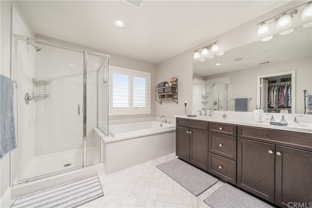 17841 Grapevine Lane San Bernardino, CA 92407 - Photo 35 of 53 a spacious bathroom with a tub sink shower and mirror