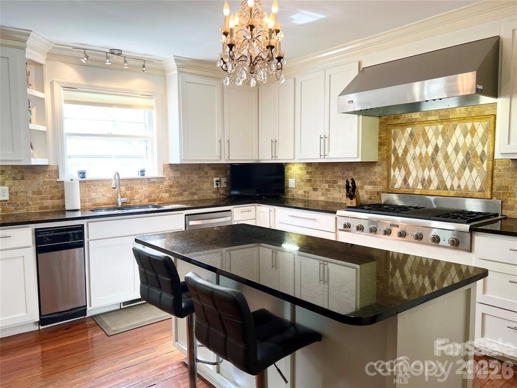 530 East Rutledge Avenue Gaffney, SC 29340 - Photo 16 of 47 a kitchen with stainless steel appliances granite countertop a sink a stove and a microwave