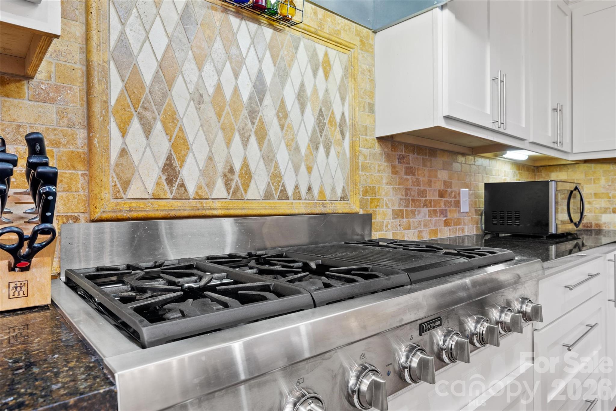 530 East Rutledge Avenue Gaffney, SC 29340 - Photo 17 of 47 a kitchen with a stove and a white cabinet