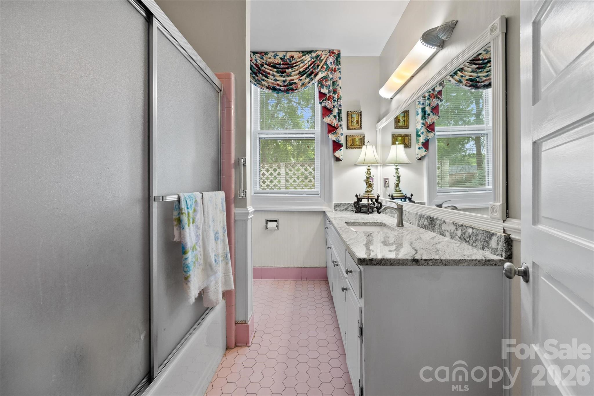530 East Rutledge Avenue Gaffney, SC 29340 - Photo 24 of 47 a bathroom with a granite countertop sink a mirror and a shower