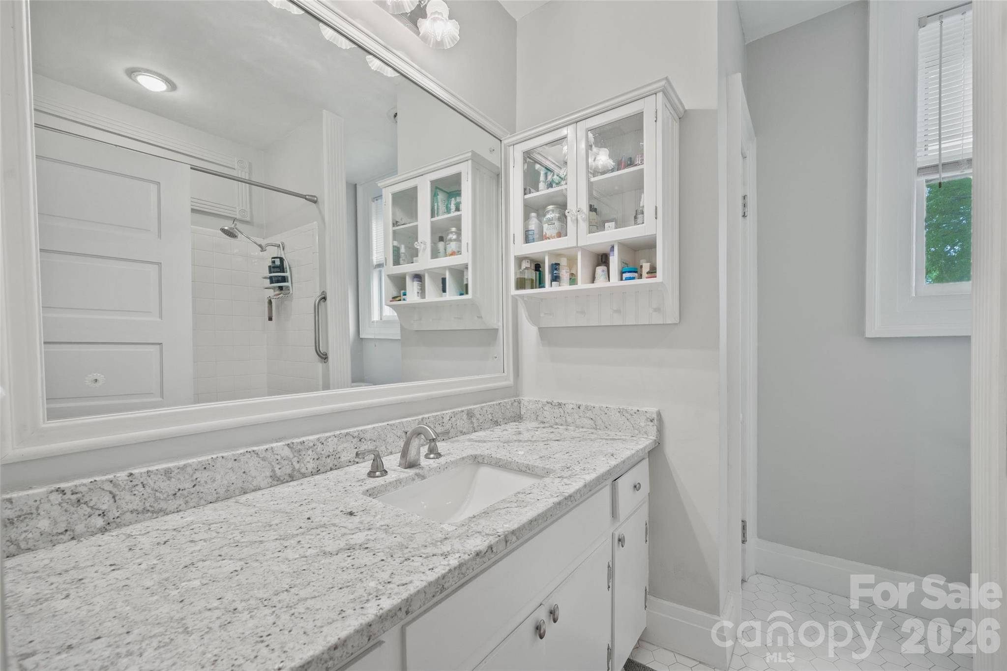 530 East Rutledge Avenue Gaffney, SC 29340 - Photo 35 of 47 a bathroom with a granite countertop sink and a mirror