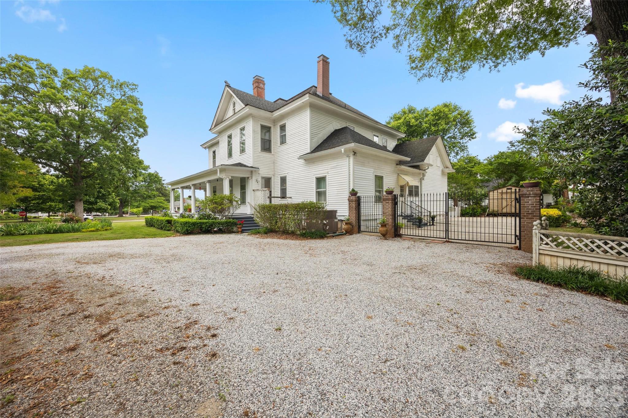 530 East Rutledge Avenue Gaffney, SC 29340 - Photo 41 of 47 a view of a white house with a big yard and large trees