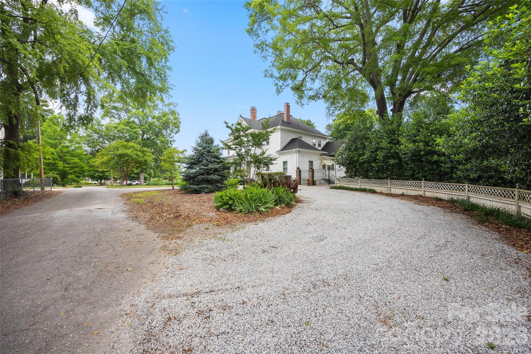 530 East Rutledge Avenue Gaffney, SC 29340 - Photo 42 of 47 a view of a yard with potted plants and large trees