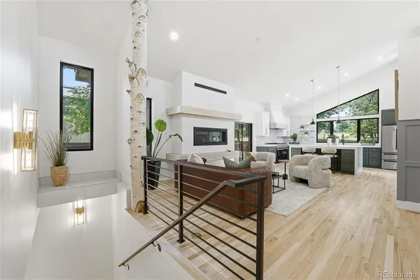 a living room with furniture a table and chairs
