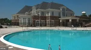 an aerial view of a house with a swimming pool