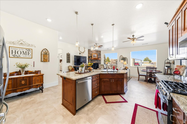 357 East Main Street Enterprise, UT 84725 - Photo 69 of 71 Kitchen with ceiling fan, light stone counters, open floor plan, decorative light fixtures, and stainless steel appliances