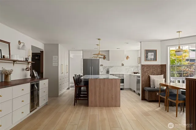 a spacious bathroom with a double vanity sink a large mirror a bathtub and shower