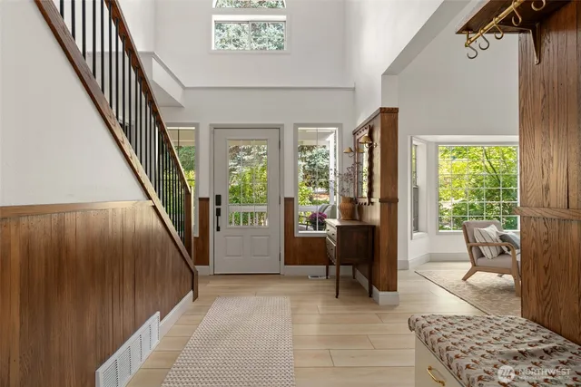 a view of a backyard with potted plants and large trees