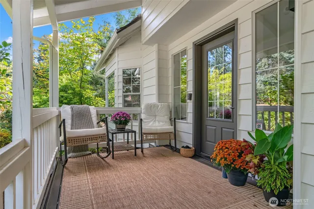 a living room with furniture a fireplace and a potted plant