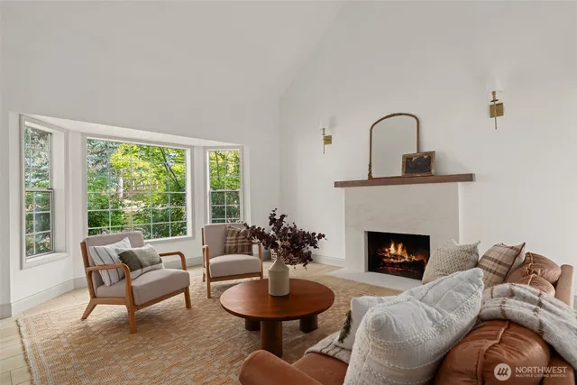 a kitchen with stainless steel appliances kitchen island granite countertop a table chairs and a view of living room