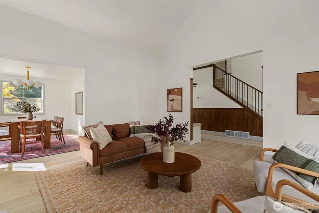 a kitchen with stainless steel appliances a dining table chairs and a window
