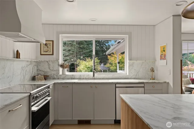 a kitchen with a table chairs refrigerator and cabinets