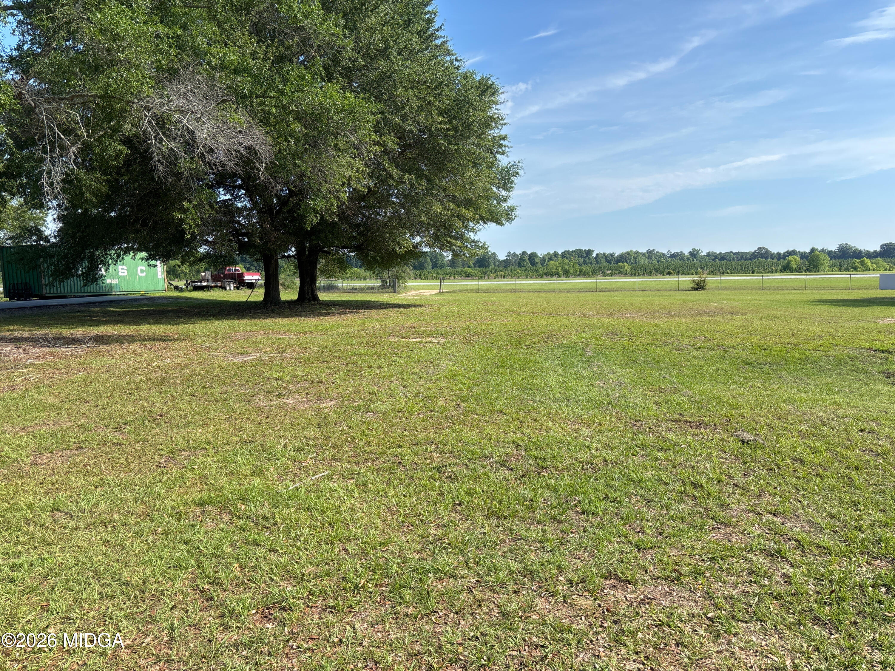 0 Lot Road Hawkinsville, GA 31036 - Photo 2 of 6 a view of a field with trees in the background