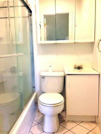 a bathroom with a toilet a sink and a shower