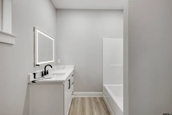 a view of white cabinets and wooden floor
