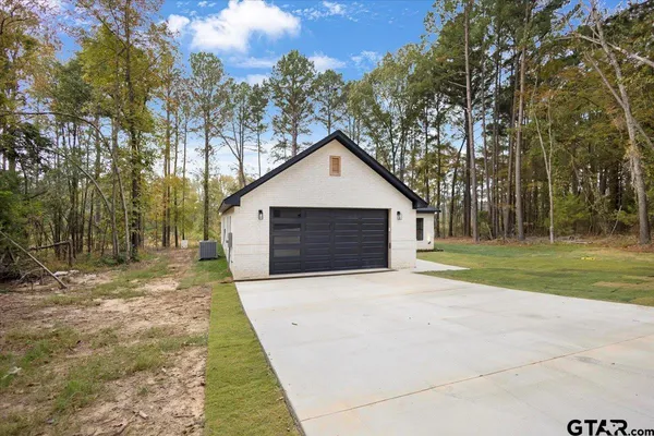 a front view of house with yard and trees
