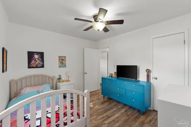 a bedroom with furniture and a flat screen tv