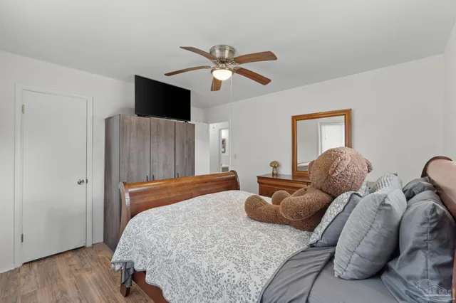 a bedroom with two beds and a flat screen tv