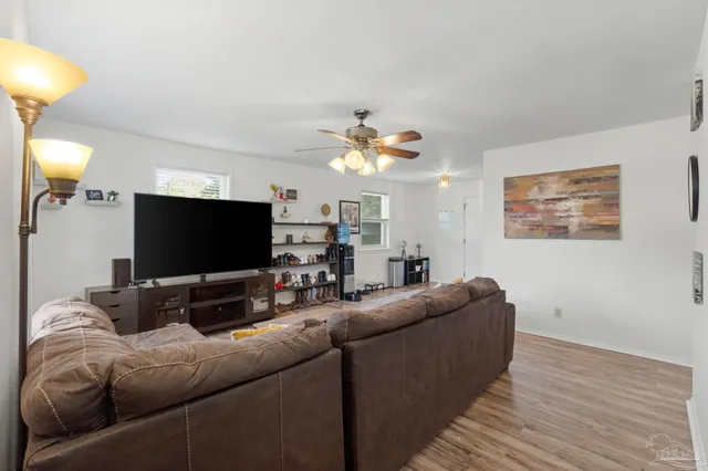 a living room with furniture and a flat screen tv