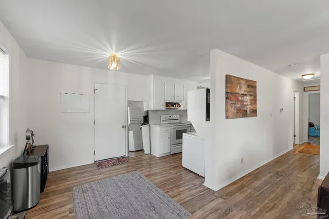 a view of a kitchen with a sink a refrigerator and window