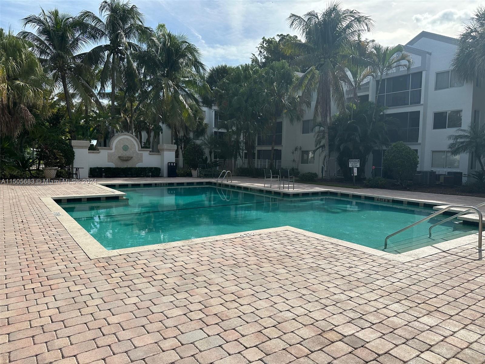 5686 Rock Island Road, Unit 134 Tamarac, FL 33319 - Photo 12 of 21 a view of pool with a yard