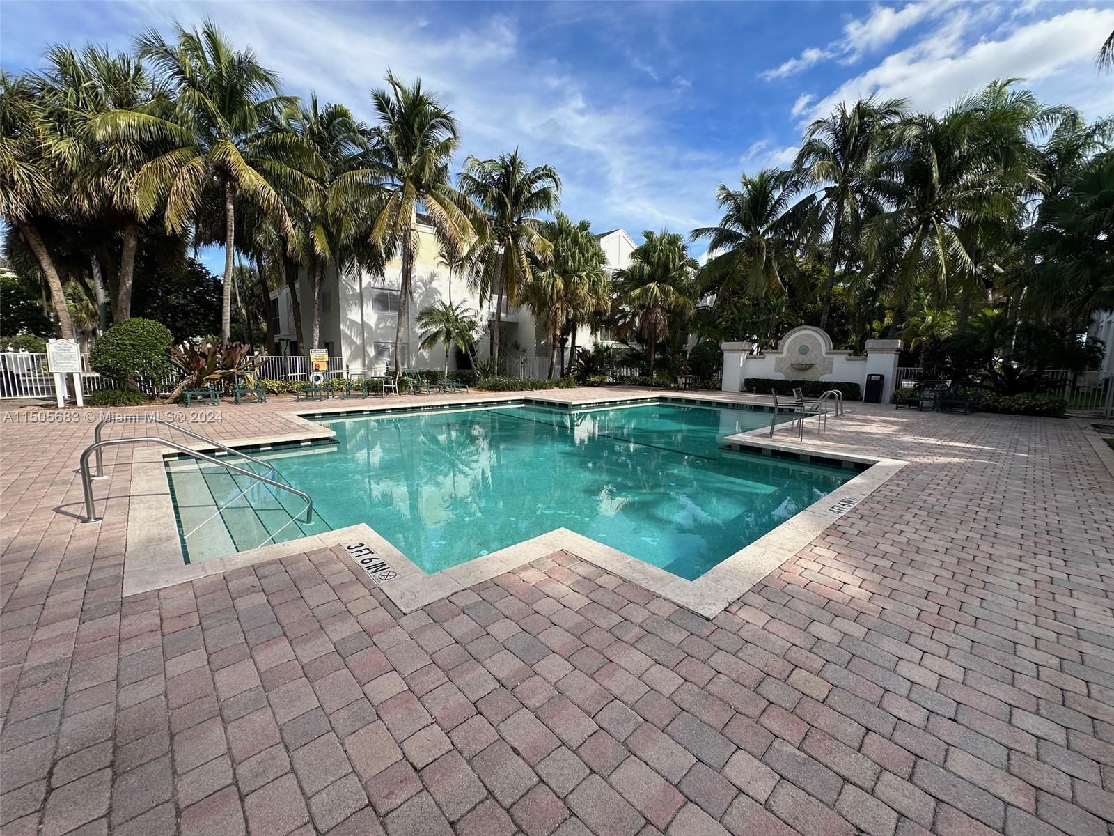 5686 Rock Island Road, Unit 134 Tamarac, FL 33319 - Photo 14 of 21 a view of a swimming pool with a garden