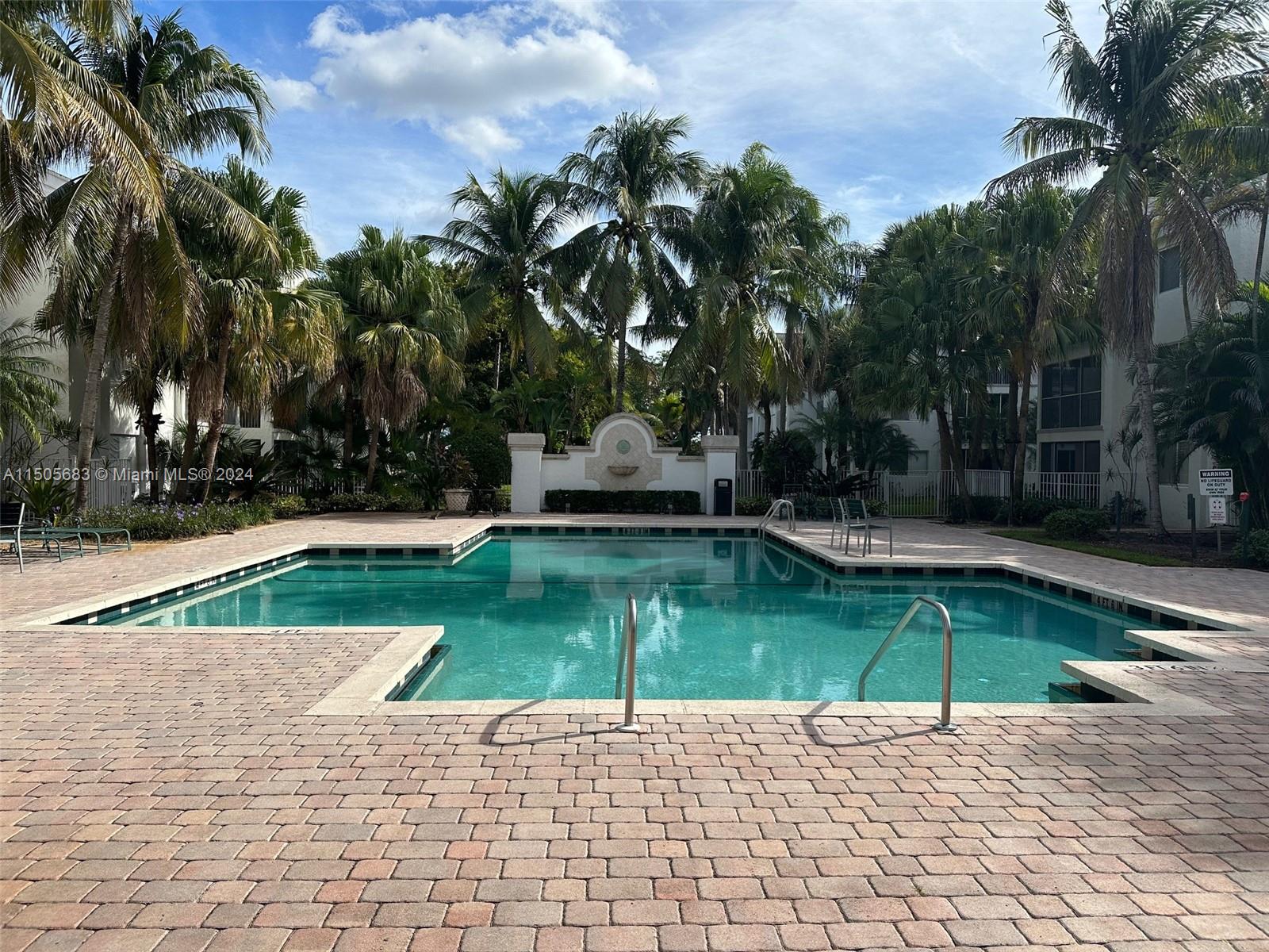 5686 Rock Island Road, Unit 134 Tamarac, FL 33319 - Photo 15 of 21 a swimming pool with outdoor seating and yard