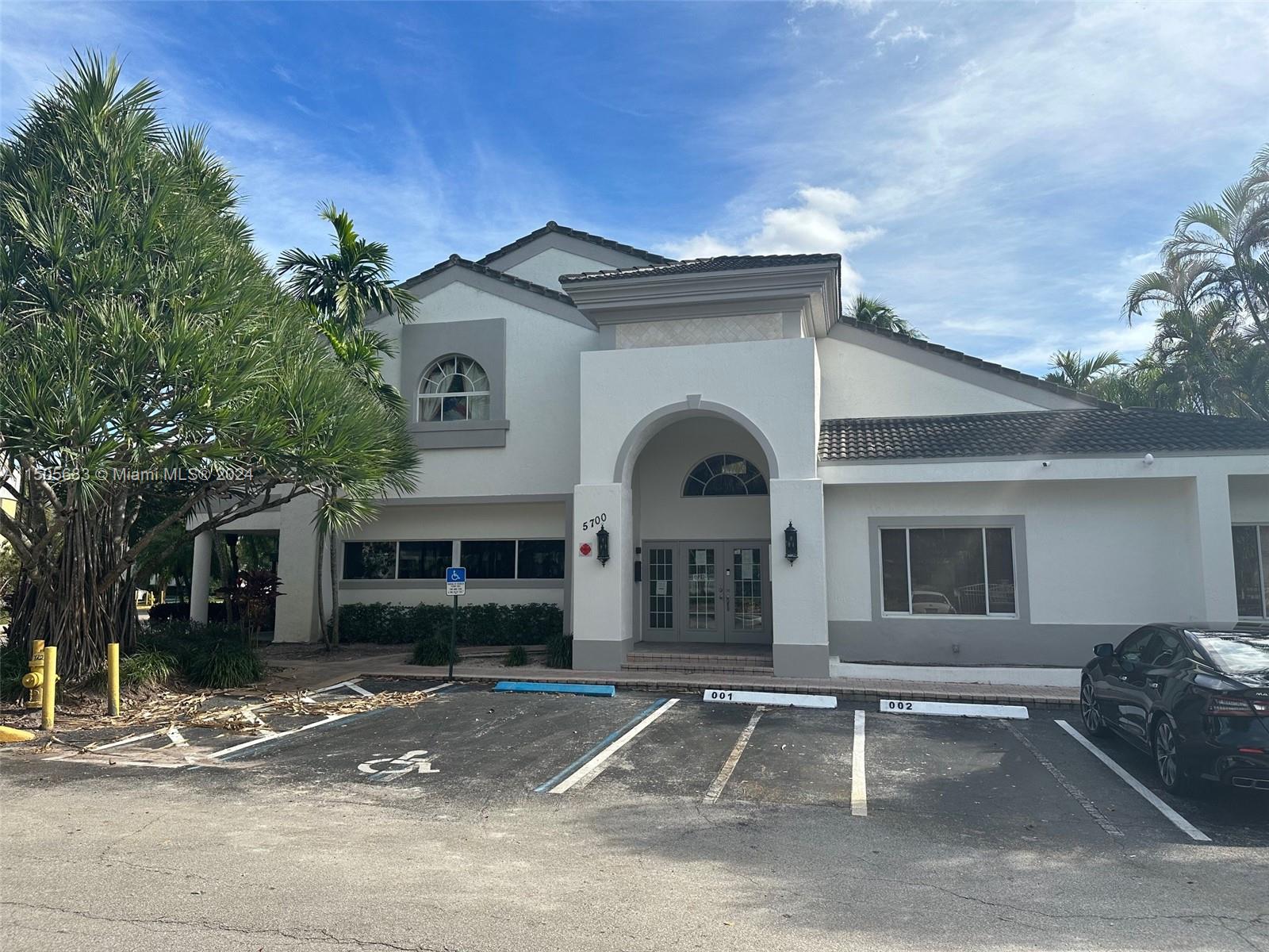 5686 Rock Island Road, Unit 134 Tamarac, FL 33319 - Photo 19 of 21 a front view of a house with a yard and garage